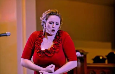 Rachel Murphy as Lily in The Secret Garden, carrying a basket of roses